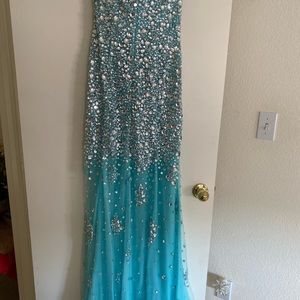 Light blue dress with beads spread throughout. Never been worn.